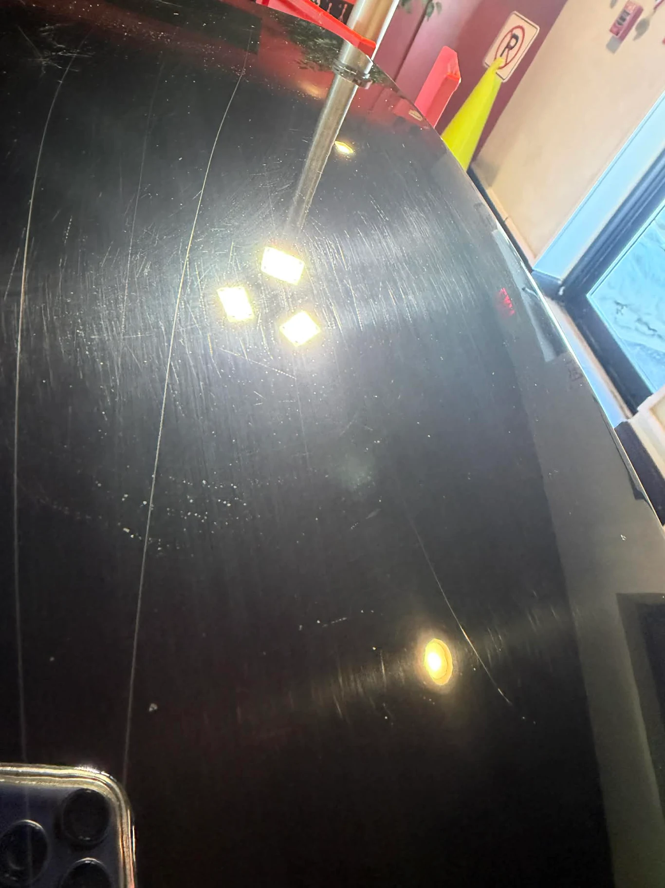 Black Harley-Davidson Road Glide before paint correction showing swirl marks and scratches